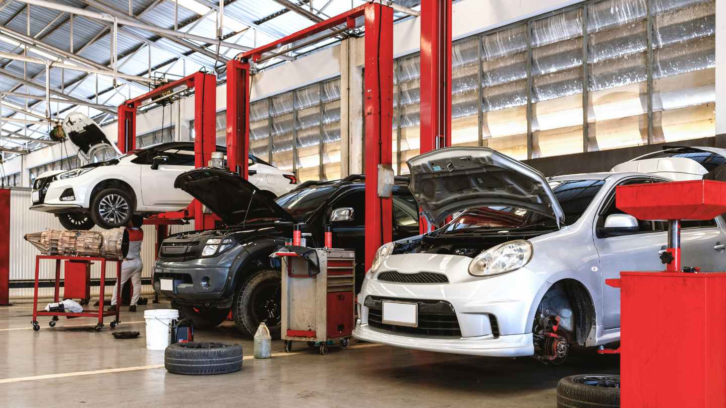 Busy repair shop with multiple vehicles being serviced