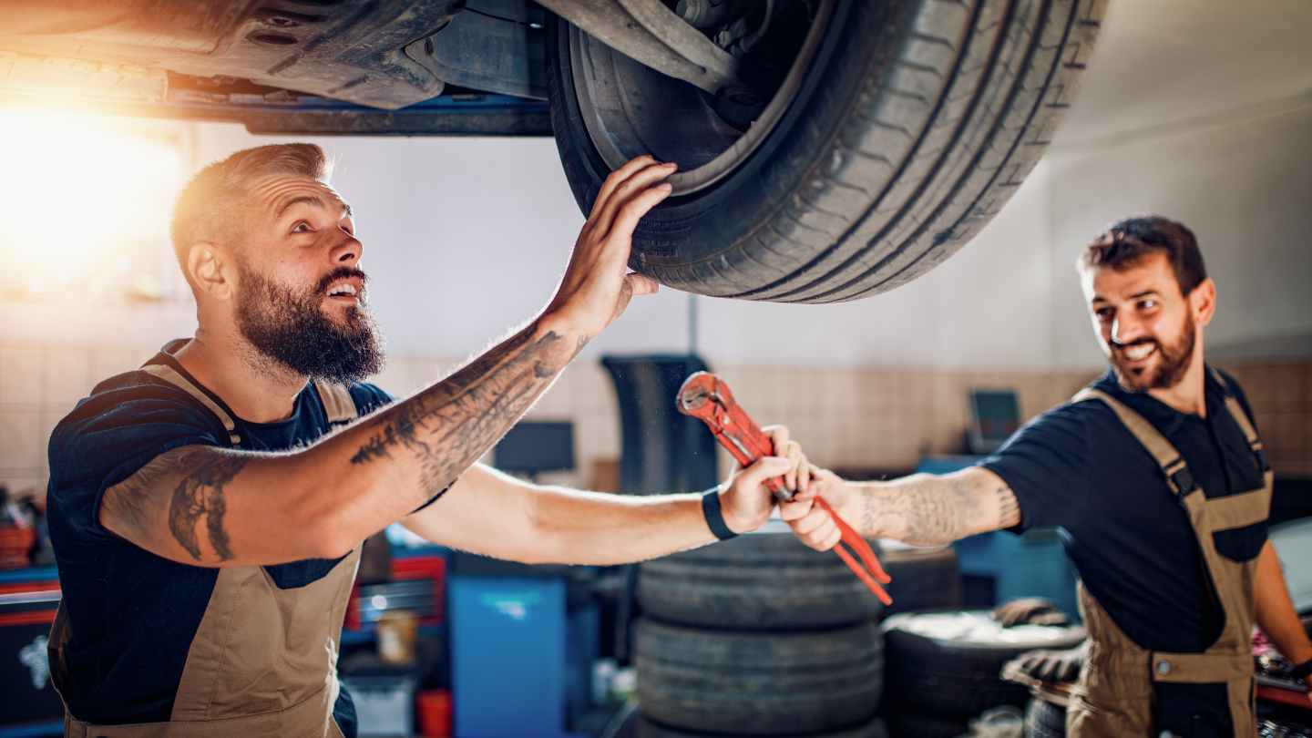 Two mechanics working together in a repair bay