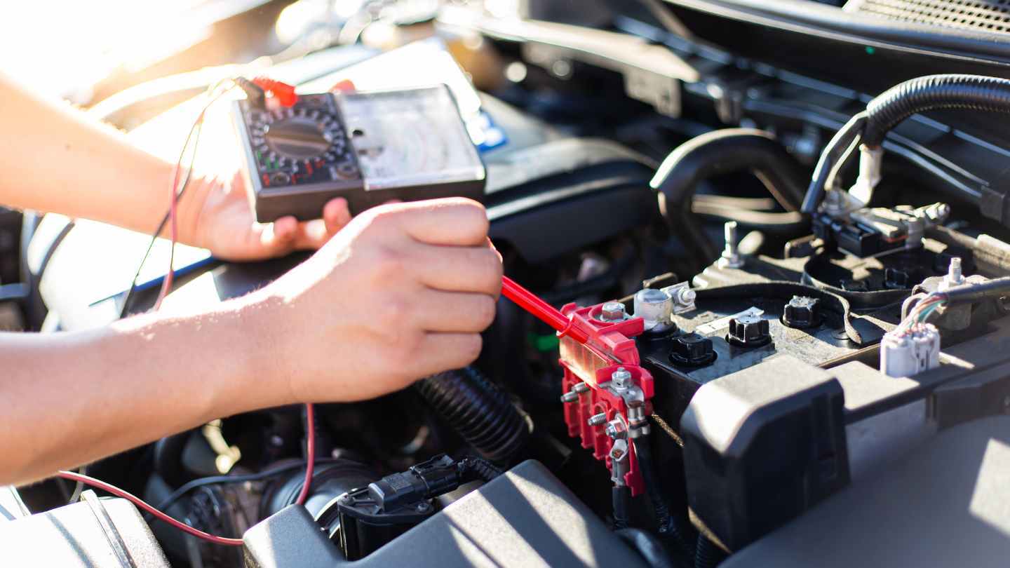 Technician testing a vehicle battery