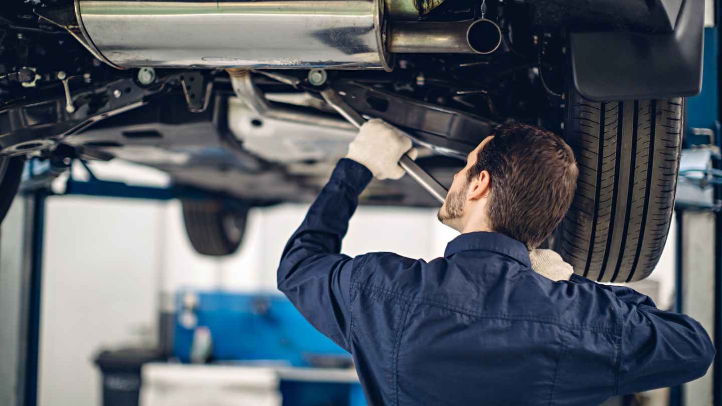 Mechanic working under a raised vehicle
