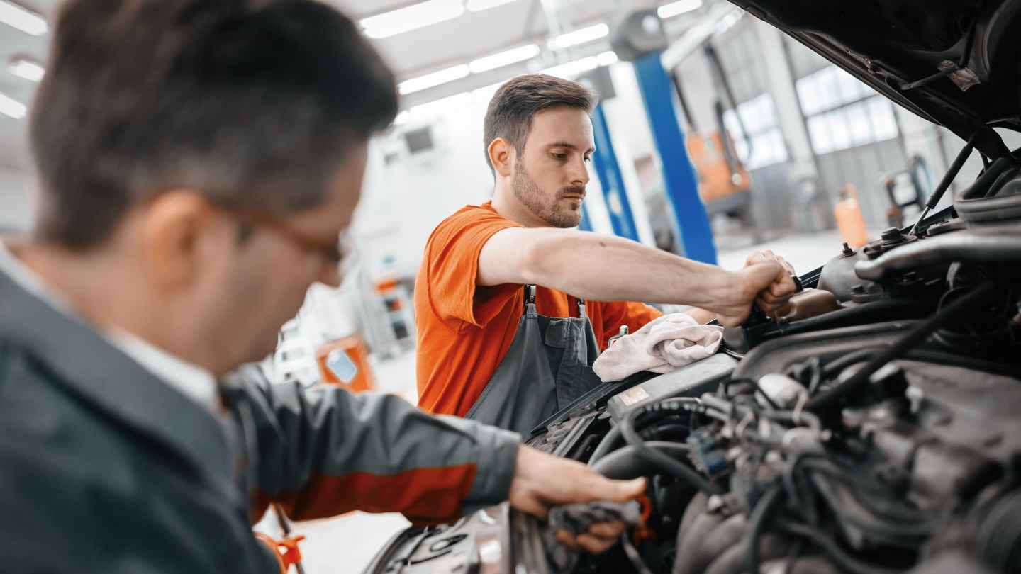 Mechanics working together in a repair bay