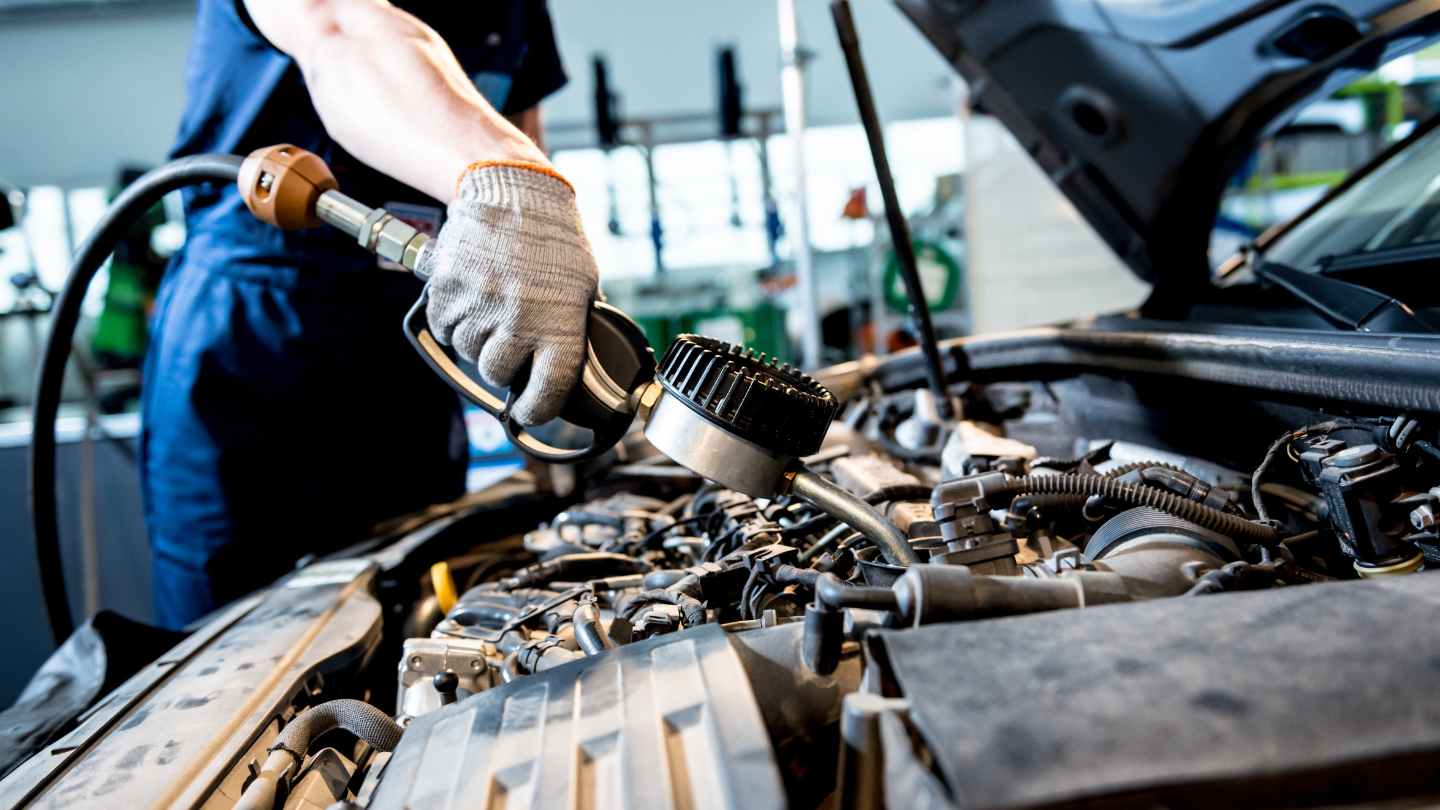 Technician adding engine fluid during service